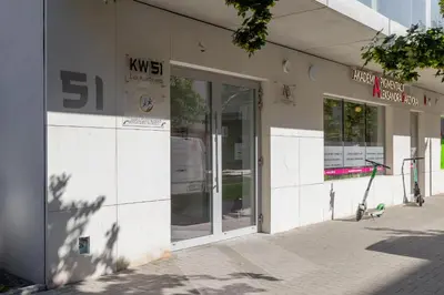 a store front with glass doors on a street at Lux Kraków Apartment with Parking & AC just 1,5 km from Main Square by Renters Prestige in Kraków