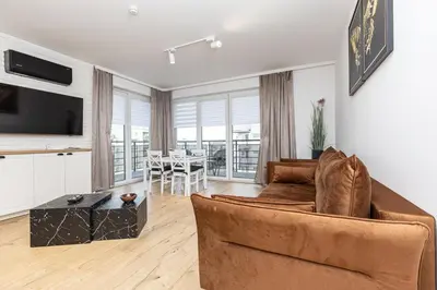 a living room with a couch and a table at Apartamenty FIGARETTI in Kraków