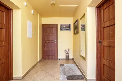 a bedroom with two chairs and a bed and a clock at Oaza Wysoka powiat wadowicki in Wysoka