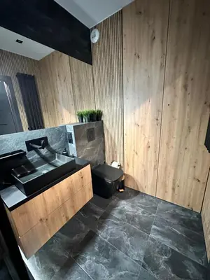 a bathroom with a sink and a toilet at Forum Apartment in Kraków