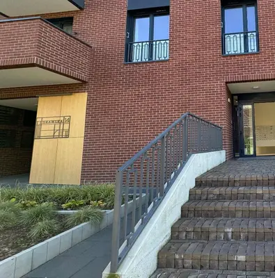 a brick building with stairs leading to a door at Forum Apartment in Kraków