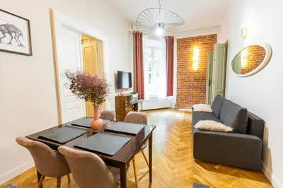 a living room with a table and a couch at Stylish apartment #2 in Krakow Old Town in Kraków
