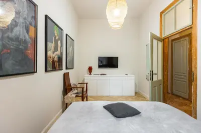 a bedroom with a bed and a tv on a wall at Stylish apartment #2 in Krakow Old Town in Kraków