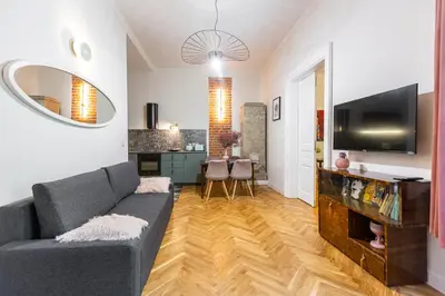 a living room with a couch and a television at Stylish apartment #2 in Krakow Old Town in Kraków
