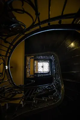 a spiral staircase with a window in a stair case at Stylish apartment #2 in Krakow Old Town in Kraków