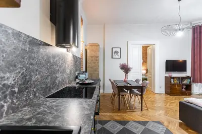 a kitchen and living room with a black counter top at Stylish apartment #2 in Krakow Old Town in Kraków