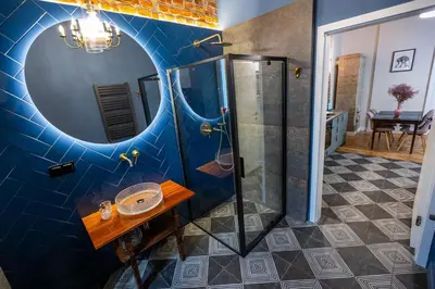 a bathroom with a shower and a mirror at Stylish apartment #2 in Krakow Old Town in Kraków