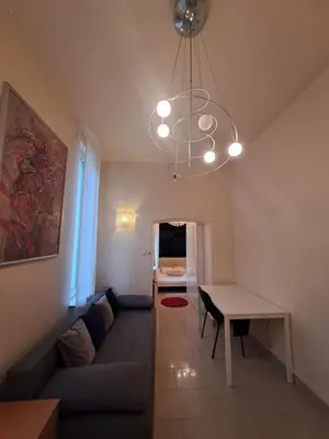 a living room with a couch and a table at Szymborska Stradomska 5 in Kraków