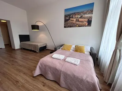 a bedroom with a bed with two towels on it at Bosacka Street - Apartament B31 in Kraków