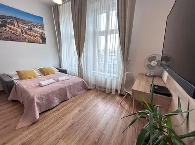 a bedroom with a bed and a large window at Bosacka Street - Apartament B31 in Kraków
