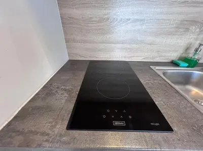 a kitchen counter with a stove top on a counter top at Bosacka Street - Apartament B31 in Kraków