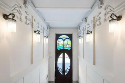 a hallway with a door with a stained glass window at Bosacka Street - Apartament B31 in Kraków