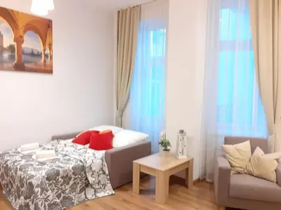 a bedroom with a bed and a couch at Bosacka Street - Apartament B26 in Kraków
