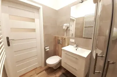 a small bathroom with a toilet and a sink at Bosacka Street - Apartament B26 in Kraków