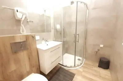 a bathroom with a shower and a toilet and a sink at Bosacka Street - Apartament B26 in Kraków