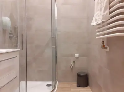 a shower with a glass door in a bathroom at Cozy Apartment - B38 in Kraków