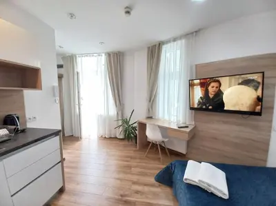 a living room with a tv on a wall at Cozy Apartment - B38 in Kraków