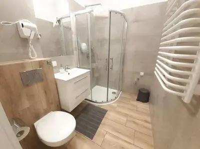 a bathroom with a shower and a toilet and a sink at Cozy Apartment - B38 in Kraków
