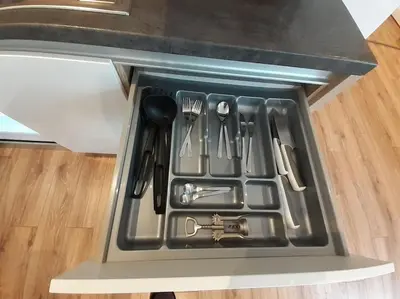 a drawer filled with utensils in a refrigerator at Cozy Apartment - B38 in Kraków