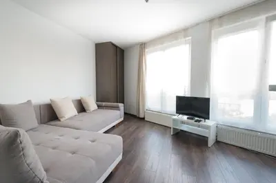 a living room with a couch and a tv at RentPlanet - Apartament Mireckiego in Kraków