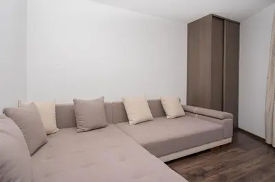 a living room with a couch and a cabinet at RentPlanet - Apartament Mireckiego in Kraków