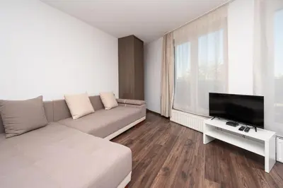 a living room with a couch and a flat screen tv at RentPlanet - Apartament Mireckiego in Kraków