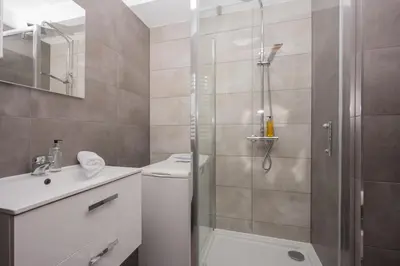 a bathroom with a shower and a toilet and a sink at RentPlanet - Apartament Mireckiego in Kraków