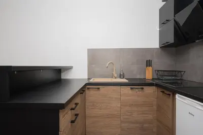 a kitchen with a sink and a counter top at RentPlanet - Apartament Mireckiego in Kraków