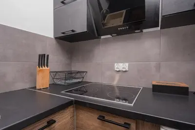 a kitchen with a sink and a microwave at RentPlanet - Apartament Mireckiego in Kraków