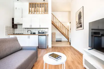 a living room with a couch and a table at Kochanowskiego 23 Apartament in Kraków