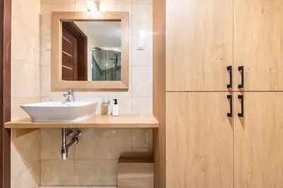 a bathroom with a sink and a mirror at Kochanowskiego 23 Apartament in Kraków