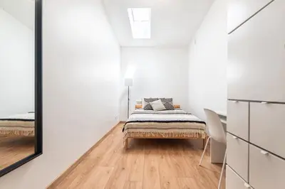 a bedroom with a bed and a mirror at Kochanowskiego 23 Apartament in Kraków