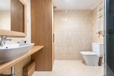 a bathroom with a sink and a toilet at Kochanowskiego 23 Apartament in Kraków