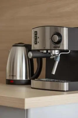 a coffee maker sitting on top of a counter at Nowoczesny Apartament w Krakowie z Klimatyzacją i Parkingiem by Noclegi Renters in Kraków