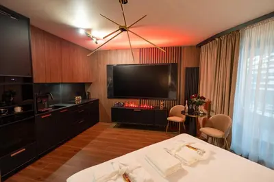 a hotel room with a bed and a flat screen tv at Apartament z jacuzzi, Wiślane Tarasy in Kraków
