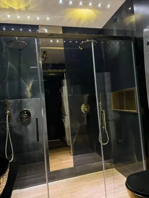 a bathroom with a walk in shower and a glass shower stall at Apartament z jacuzzi, Wiślane Tarasy in Kraków
