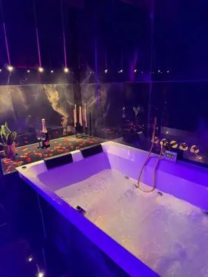 a bathroom with a bath tub with candles in it at Apartament z jacuzzi, Wiślane Tarasy in Kraków