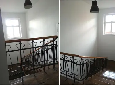 a staircase in an empty room with a window at Yellow Peaked Shoe Apartment in Kraków