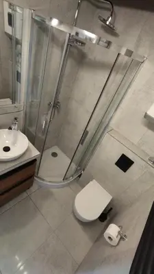 a bathroom with a shower and a toilet and a sink at Yellow Peaked Shoe Apartment in Kraków