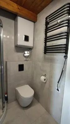 a bathroom with a toilet and a roll of toilet paper at Yellow Peaked Shoe Apartment in Kraków