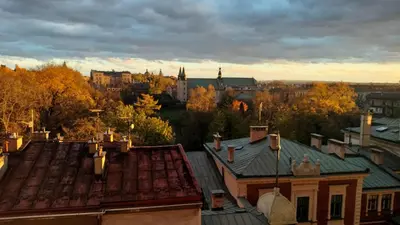 an aerial view of a city with trees and buildings at Yellow Peaked Shoe Apartment in Kraków
