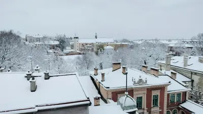 a city covered in snow with roofs at Yellow Peaked Shoe Apartment in Kraków