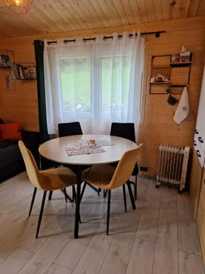 a dining room with a table and chairs in a room at Lavendowa oaza in Kocierz Rychwałdzki