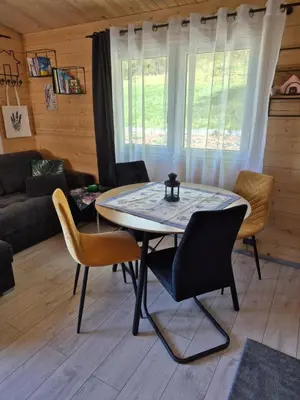 a living room with a table and a kitchen at Lavendowa oaza in Kocierz Rychwałdzki