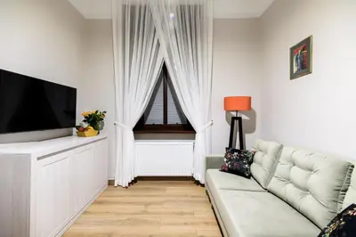 a living room with a couch and a television at Old Town AC apartments Main Raiway Station in Kraków