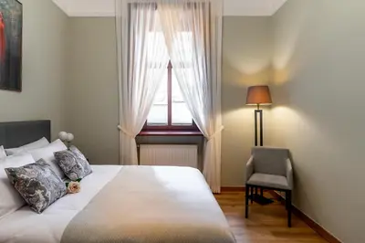 a bedroom with a bed with a window and a chair at Old Town AC apartments Main Raiway Station in Kraków