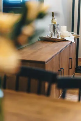 a table with glasses and a bottle on it at Old Town AC apartments Main Raiway Station in Kraków