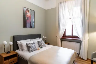a bedroom with a bed and a window at Old Town AC apartments Main Raiway Station in Kraków