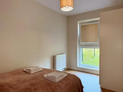 a bedroom with a bed with two towels on it at Wieli Apartment in Wieliczka