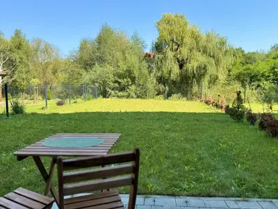 a picnic table and a bench and a field of grass at Wieli Apartment in Wieliczka